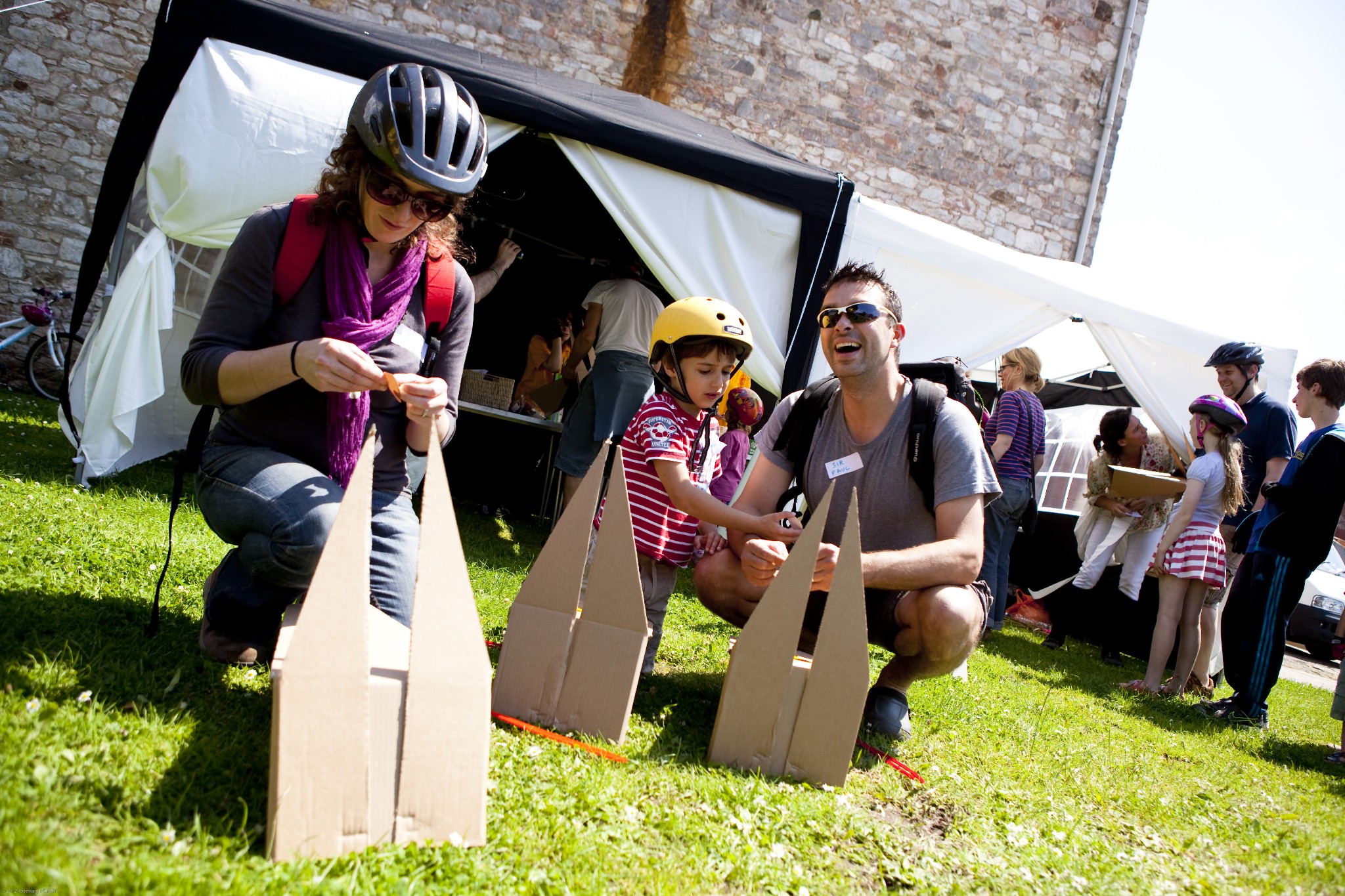 A family work on cardboard horses head in a pre-show workshop.