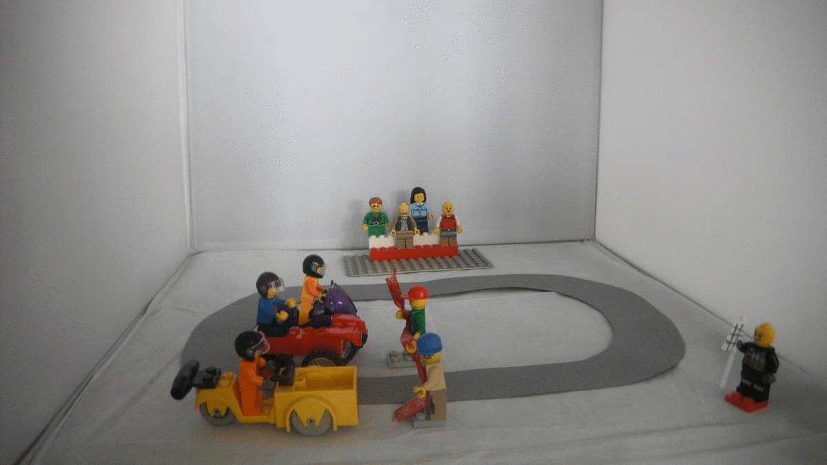 Lego speedway race starts and is going well, until one of the riders crashes. The race is stopped, and the crowd are shocked.